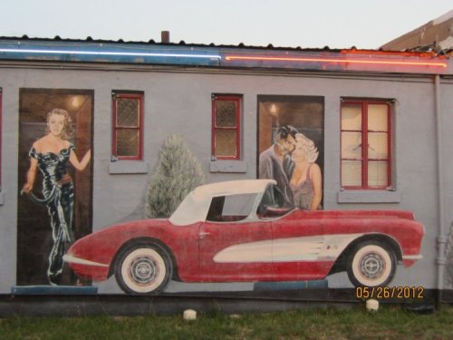 Whether it's John Kennedy or Madonna in the room behind her probably isn't an issue worth fretting about.  Besides, she mightn't even be female.