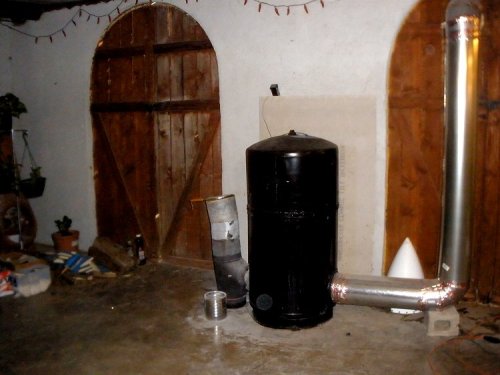 The Cantina area of Eddie's and Val's home is just under 1000 square feet, uninsulated mostly.  The wooden doors open to a patio and you can see daylight through them.