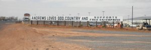 21st Century cemeteries mostly require stones to be flat with the ground and uniform in size to allow only a name and birth/death dates.  However, this sign outside Andrews, Texas offers a potential solution for communities everywhere.  A single stone the size of the Vietnam Memorial Wall telling everything the people in the cemetery believed would be a huge benefit.