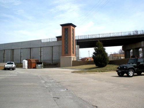 As you see in the photo the nearby dumpster provides easy diving as well as convenient disposal of garbage accumulations for community volunteers policing the area.  Note also the 'donation' bin located middle right.  Nearby residents are thereby able to voluntarily dispose of items of their own choosing rather than having things stolen willy-nilly from their vehicles and homes.  A pad located at the donation bin informs residents of the high-rise of who is contributing, and who is not carrying part of the load voluntarily.